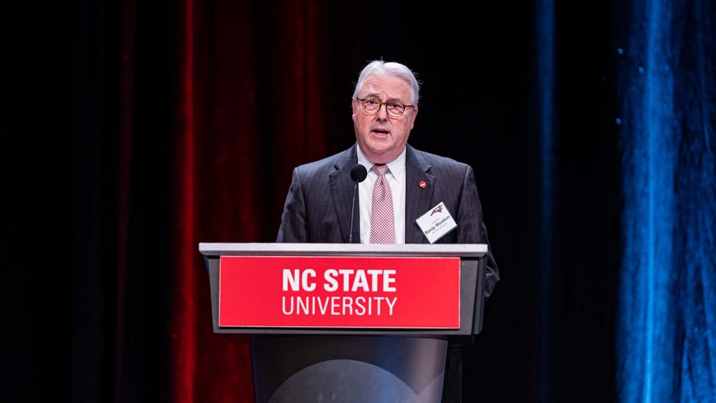 Chancellor Randy Woodson at podium at forum.