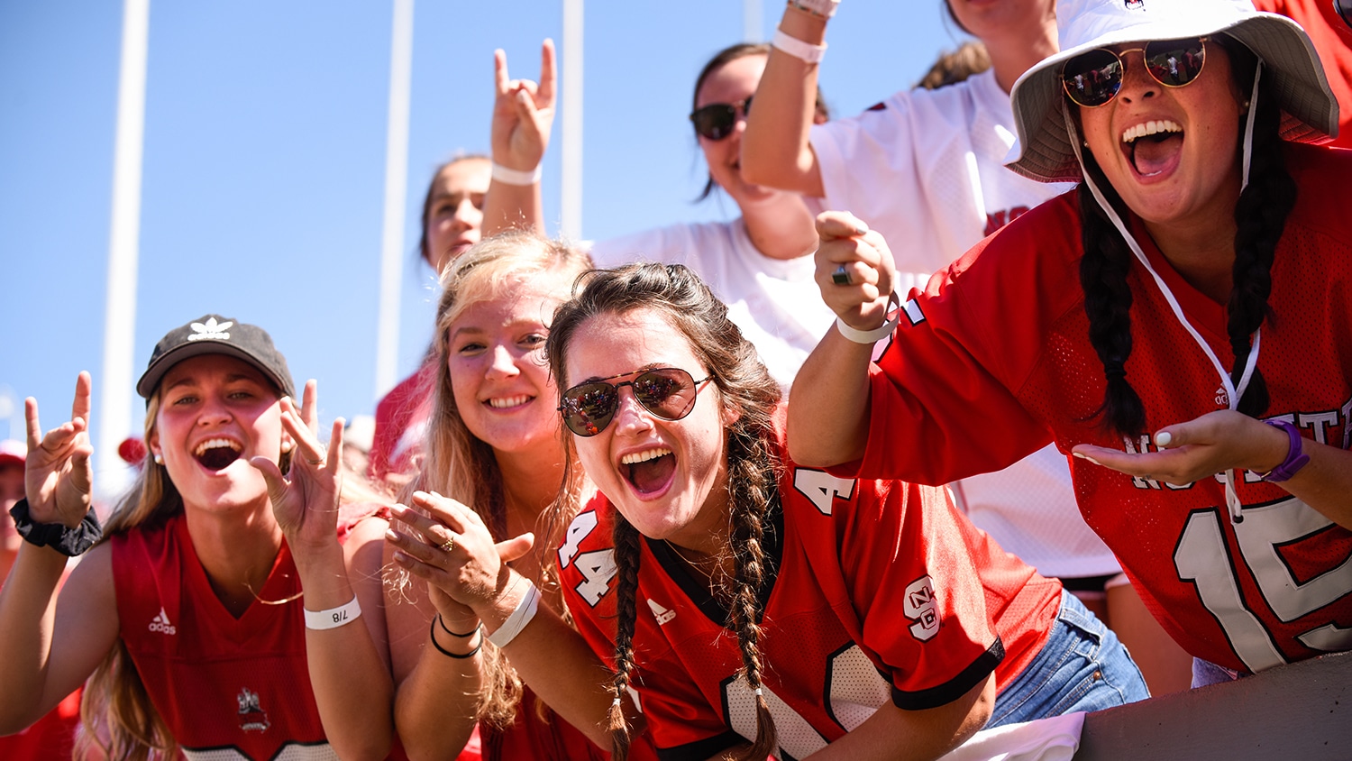 Students cheer at a football game.