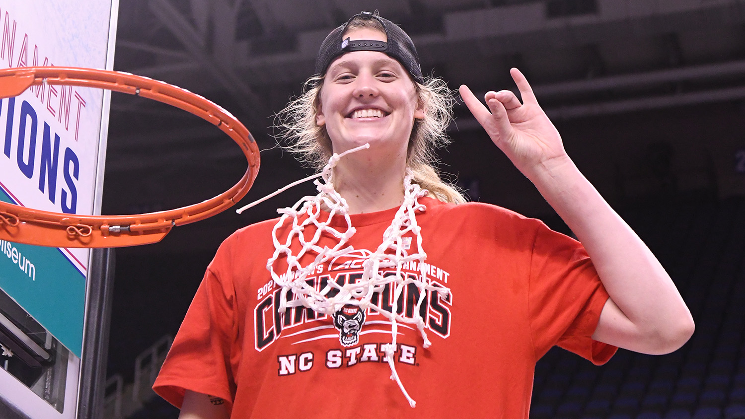 Elissa Cunane cutting down the net after a championship game.