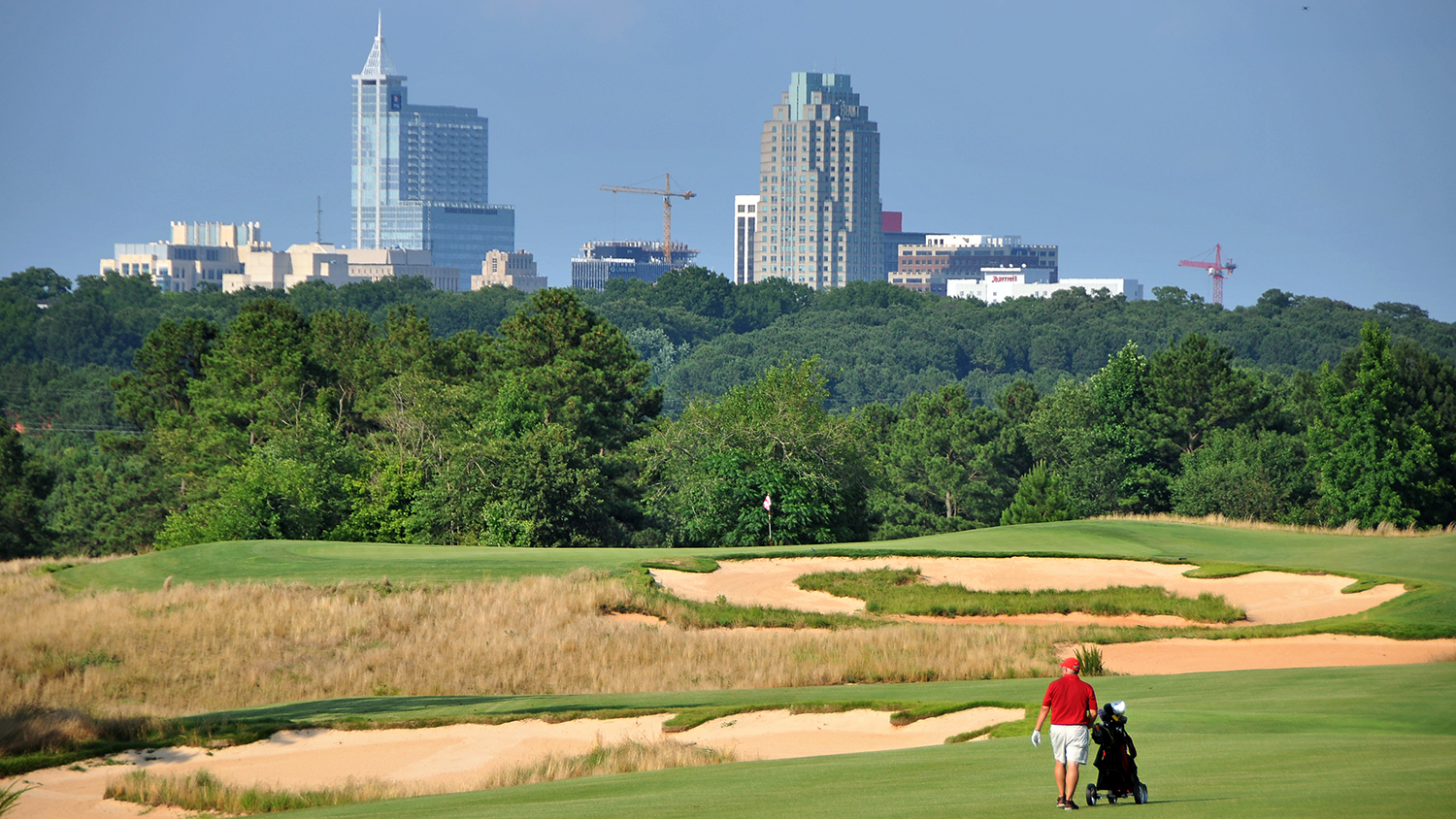 Golfer makes his way to the 11th green on the Lonnie Poole Golf Course.