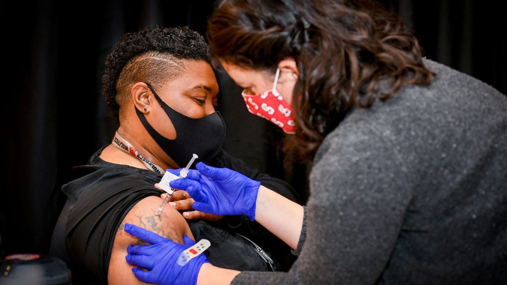 Natasha Gaddy receives the first COVID-19 at NC State's on-campus vaccination clinic.