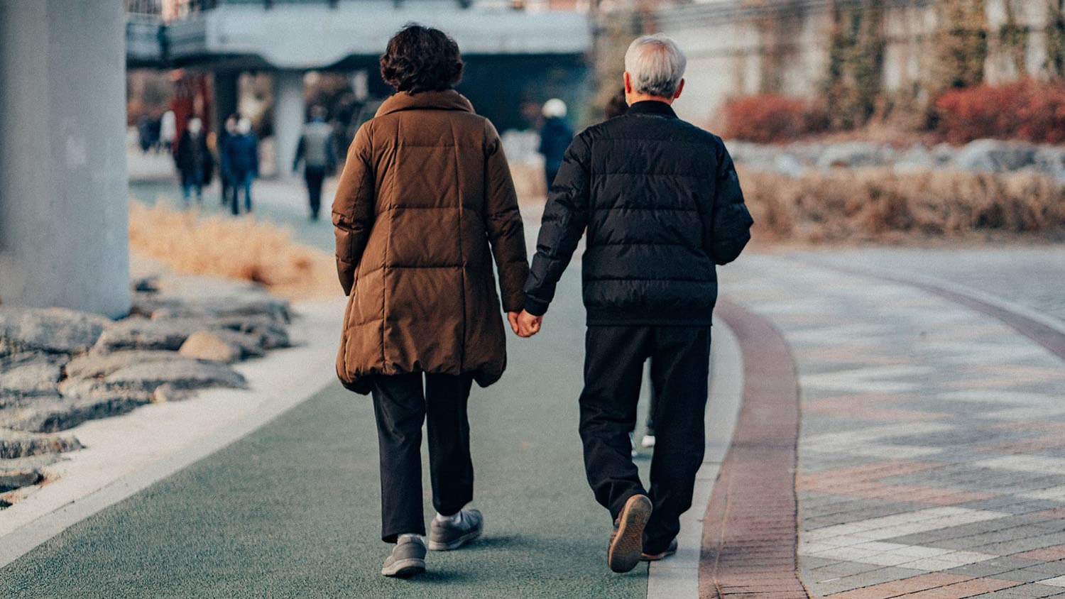 an older couple walks down the street