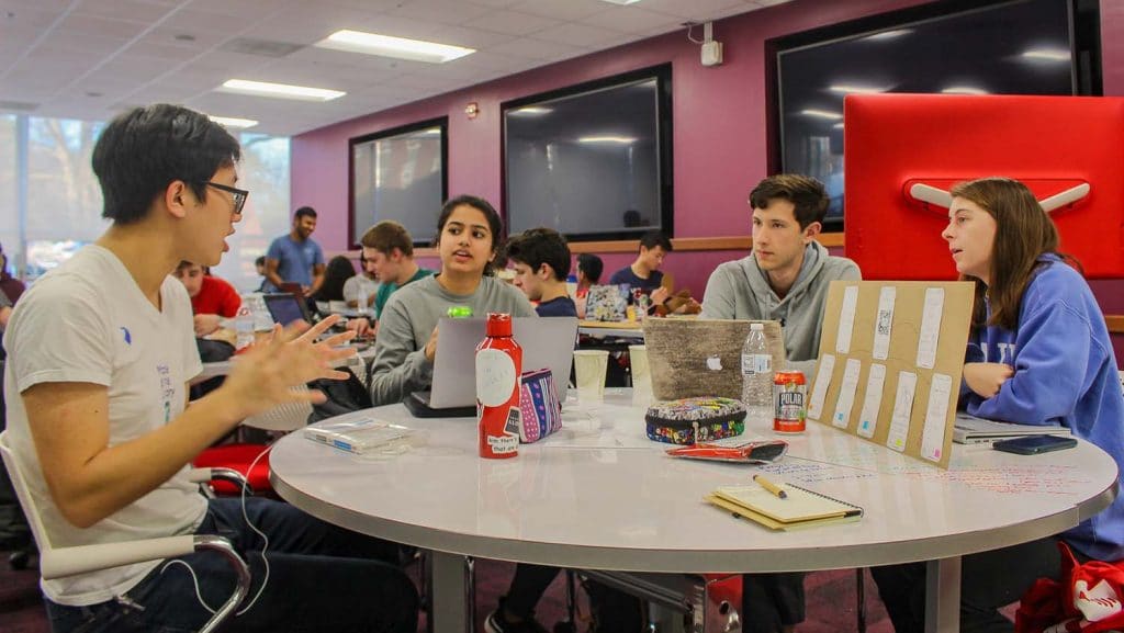 A student team discusses their solution to a sustainability challenge during Make-A-Thon