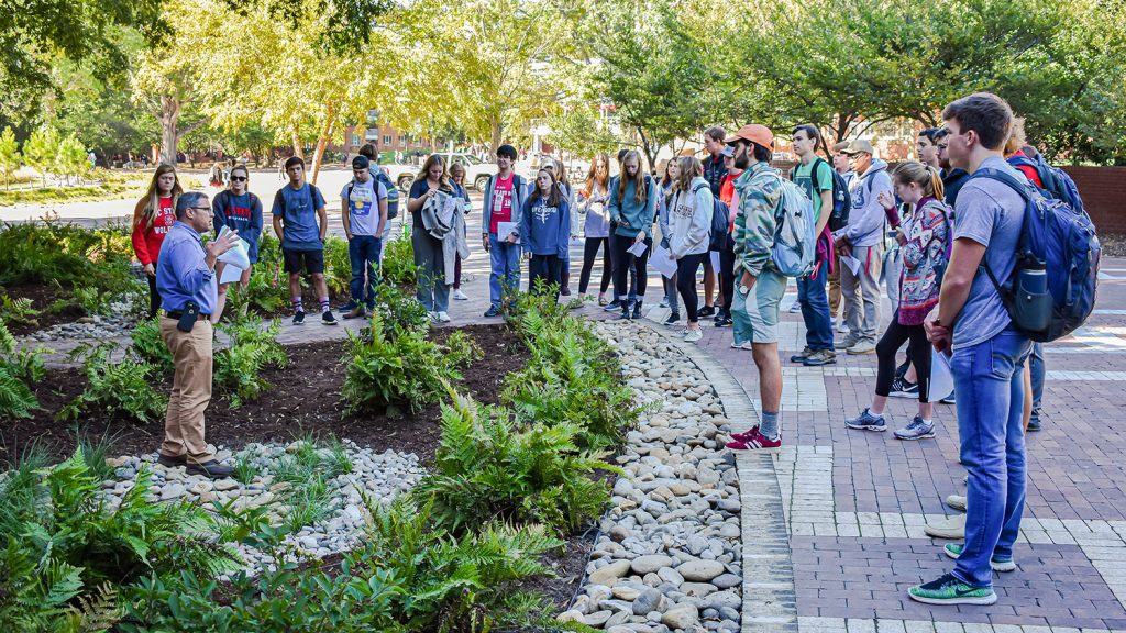 Students learn about water quality during an outside class through the Environmental First Year Program.