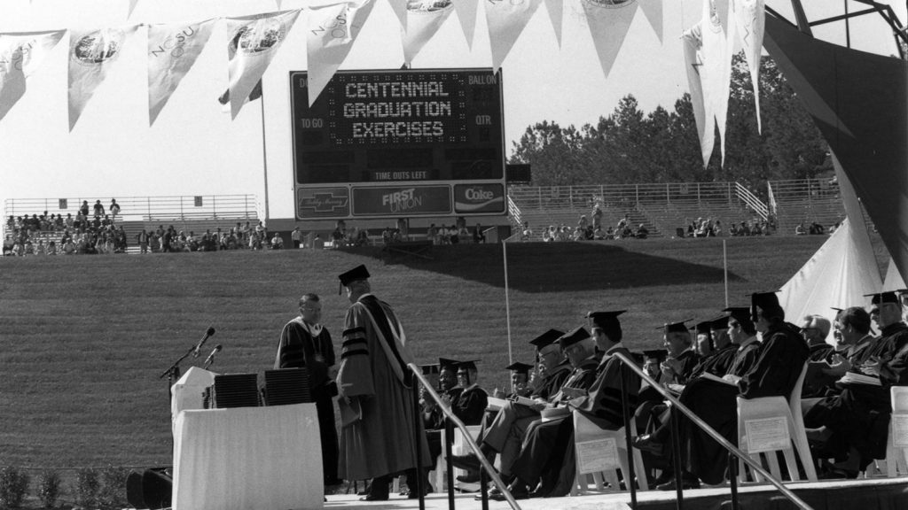 Dignitaries on the platform at NC State's 1987 outdoor commencement ceremony.