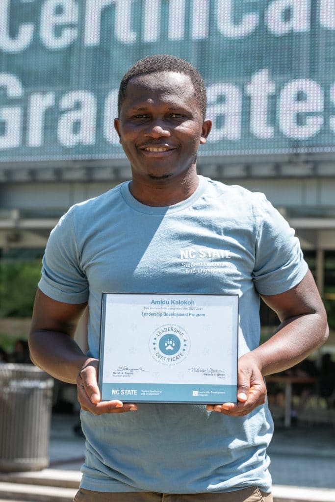 Amidu Kalokoh holds the Leadership Certificate he received from the Leadership Development Program in April. 