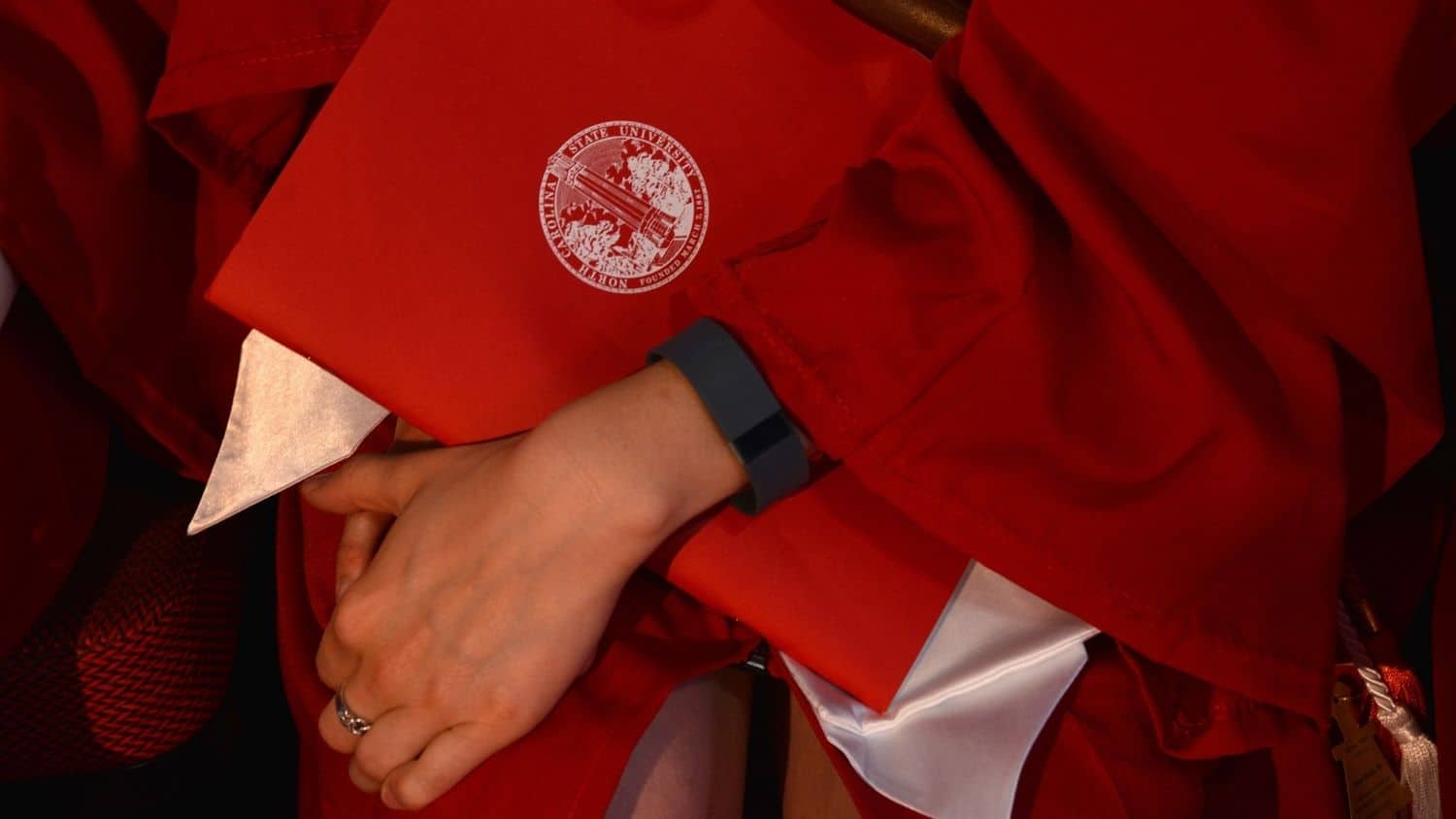 An NC State student displays their cap and gown.