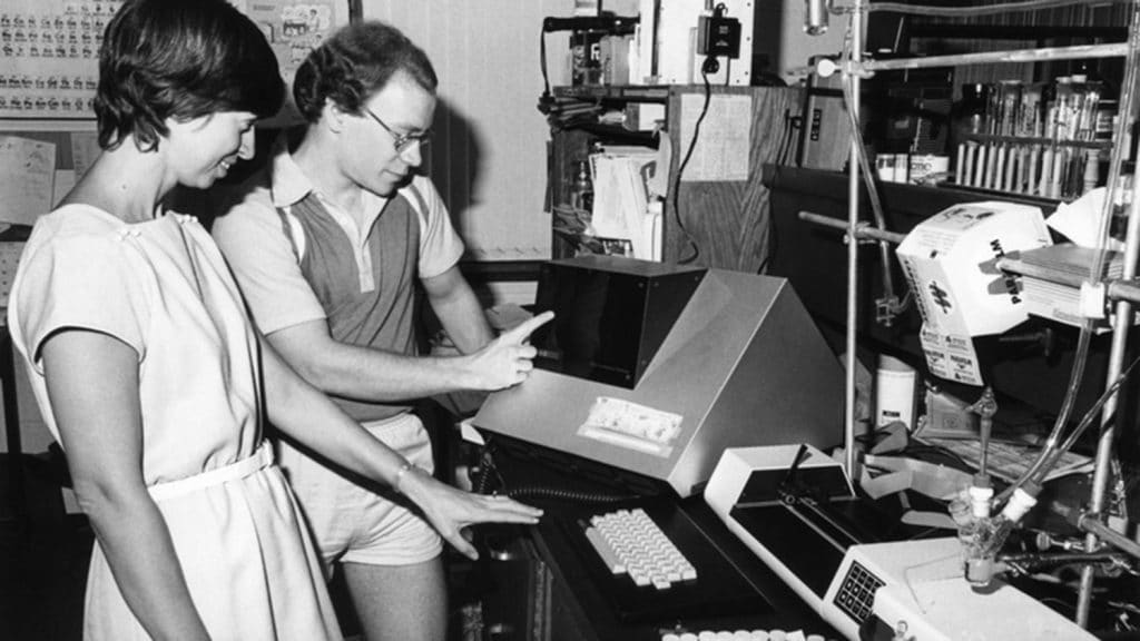 In 1980s photo, Marye Anne Fox examines lab equipment with unidentified colleague.