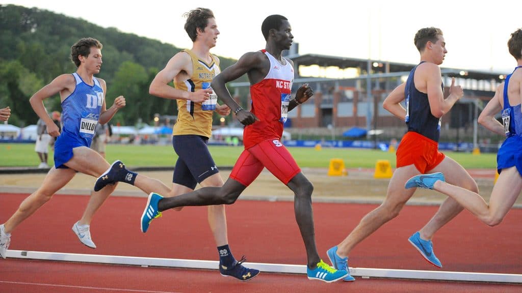 Edwin Rutto in a pack of runners nearing the finish line.