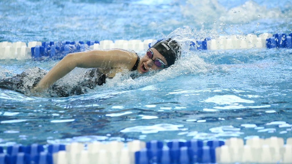 Sirena Rowe swimming side stroke in a pool.