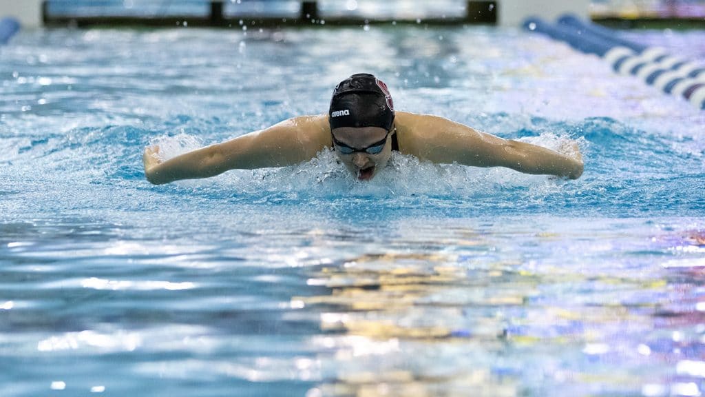 Rowe swimming the butterfly toward the camera.