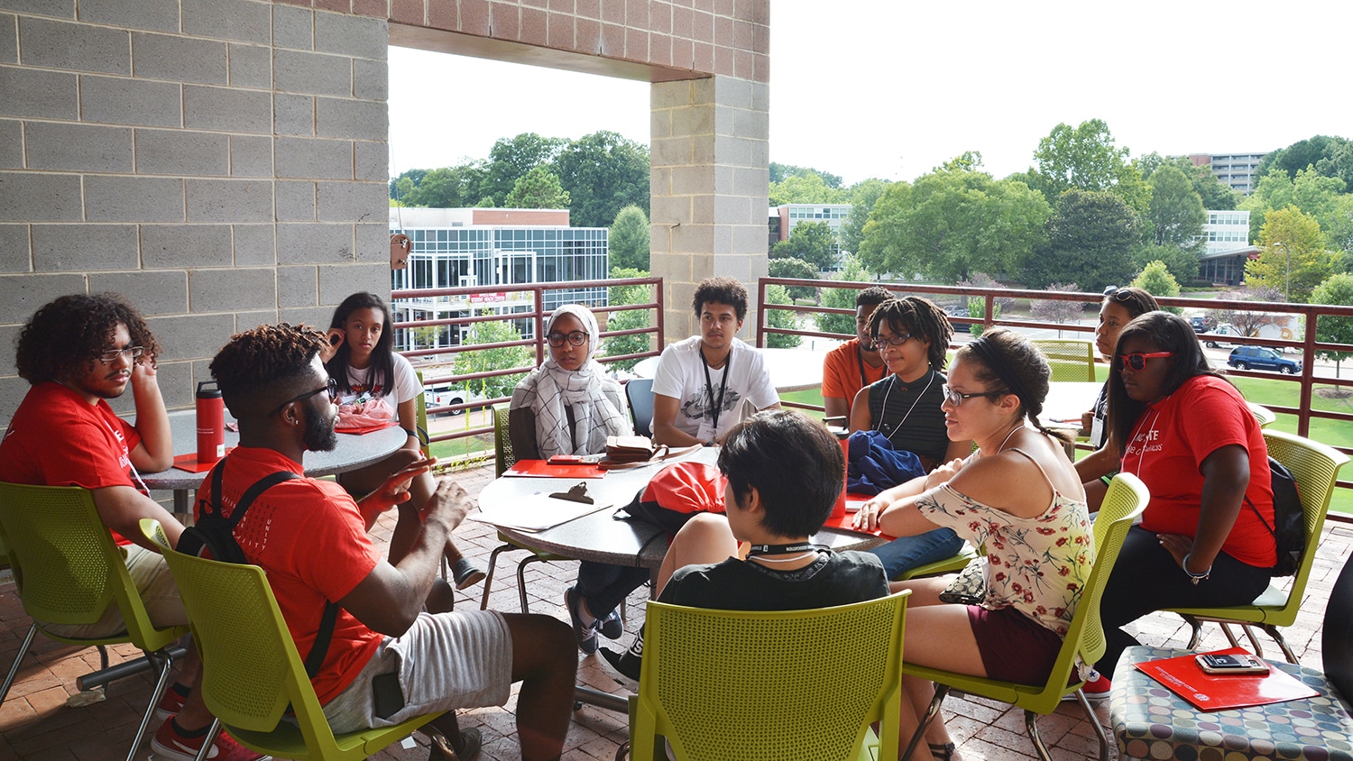 Students sitting around a table participate in a discussion session during the Symposium for Multicultural Scholars