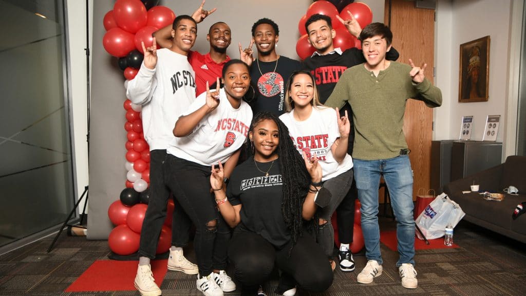 A diverse group of students celebrates graduation