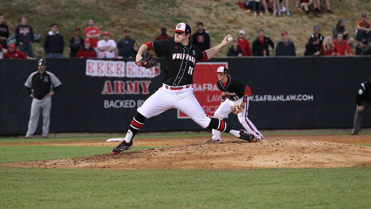 Rodon throws a pitch at a Wolfpack baseball game.