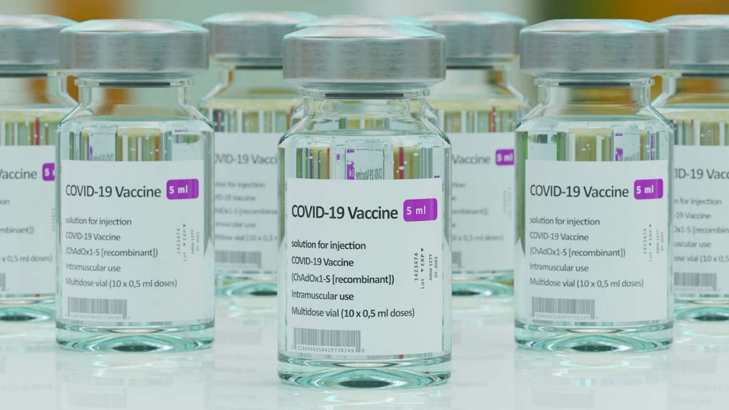 a shelf covered with vials of COVID-19 vaccine
