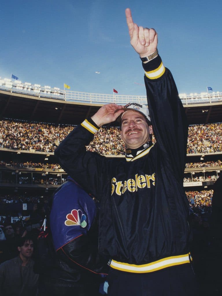 Cowher celebrating a Super Bowl victory on the field.