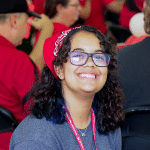 A smiling student in a red bandana.