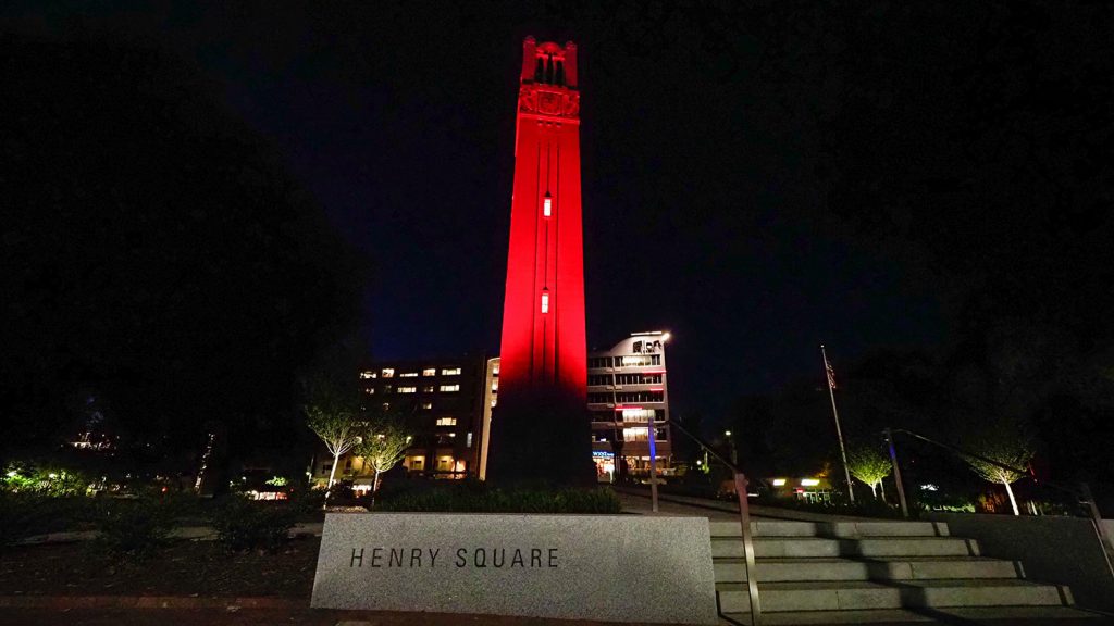 NC State's Memorial Belltower lit red at night