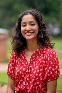 Meghan Tanaka sits for a portrait outside on campus.