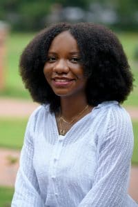 Rafeeat Aliyu sits for a portrait outside on campus.