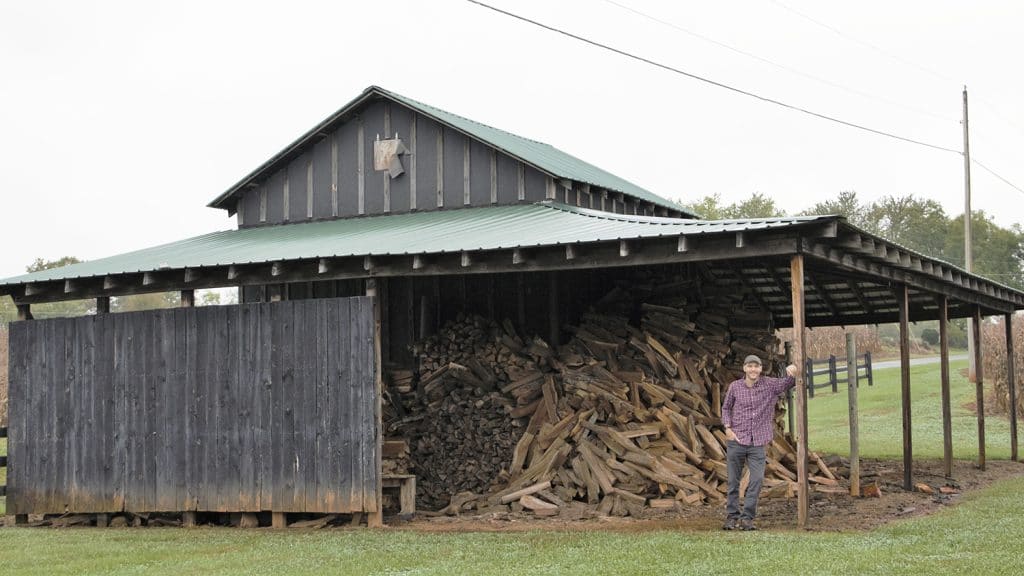 Winemaker Ethan Brown poses in an old tobacco barn at the vineyard.