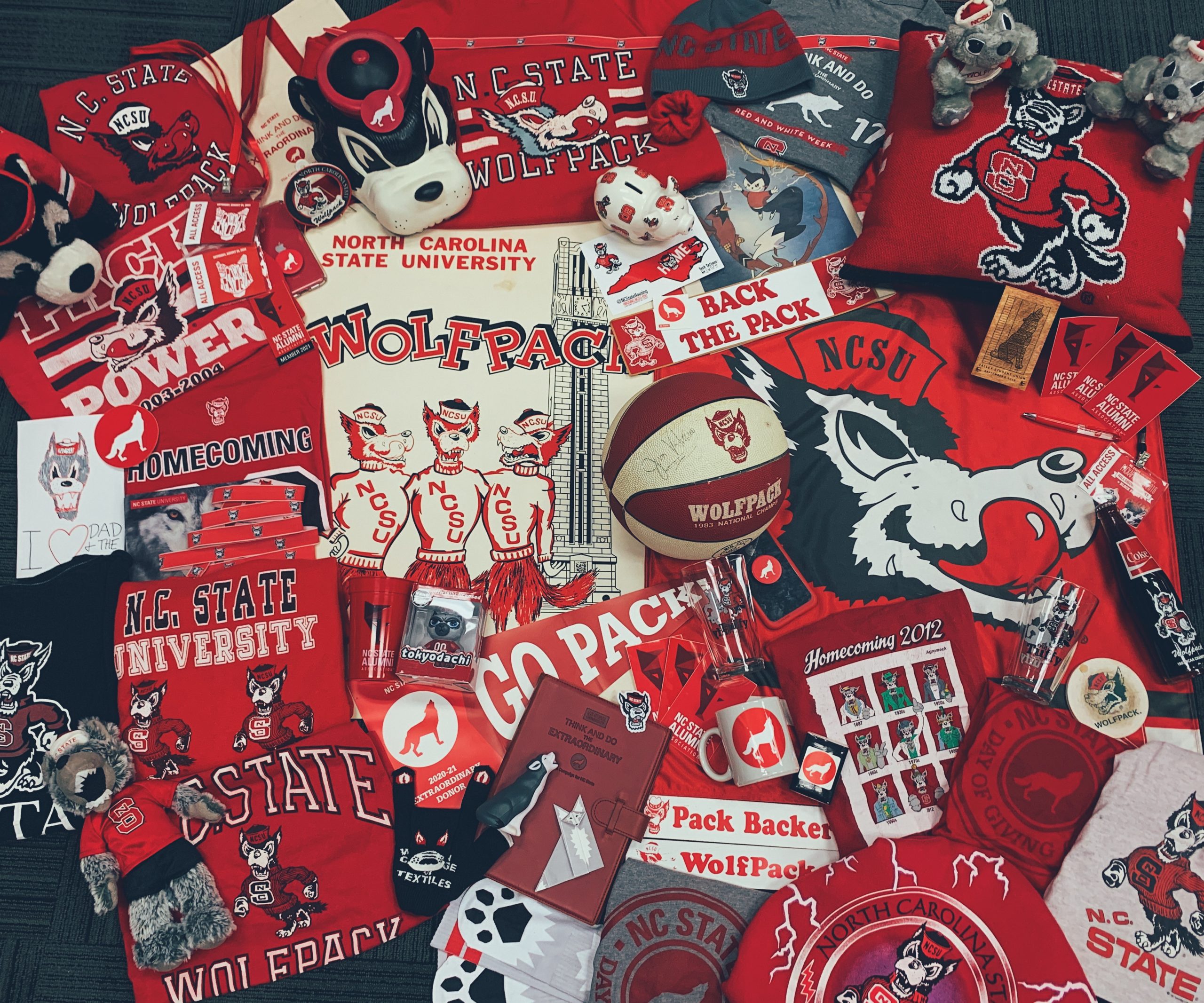 A flat lay image filled with various Wolfpack-themed items.