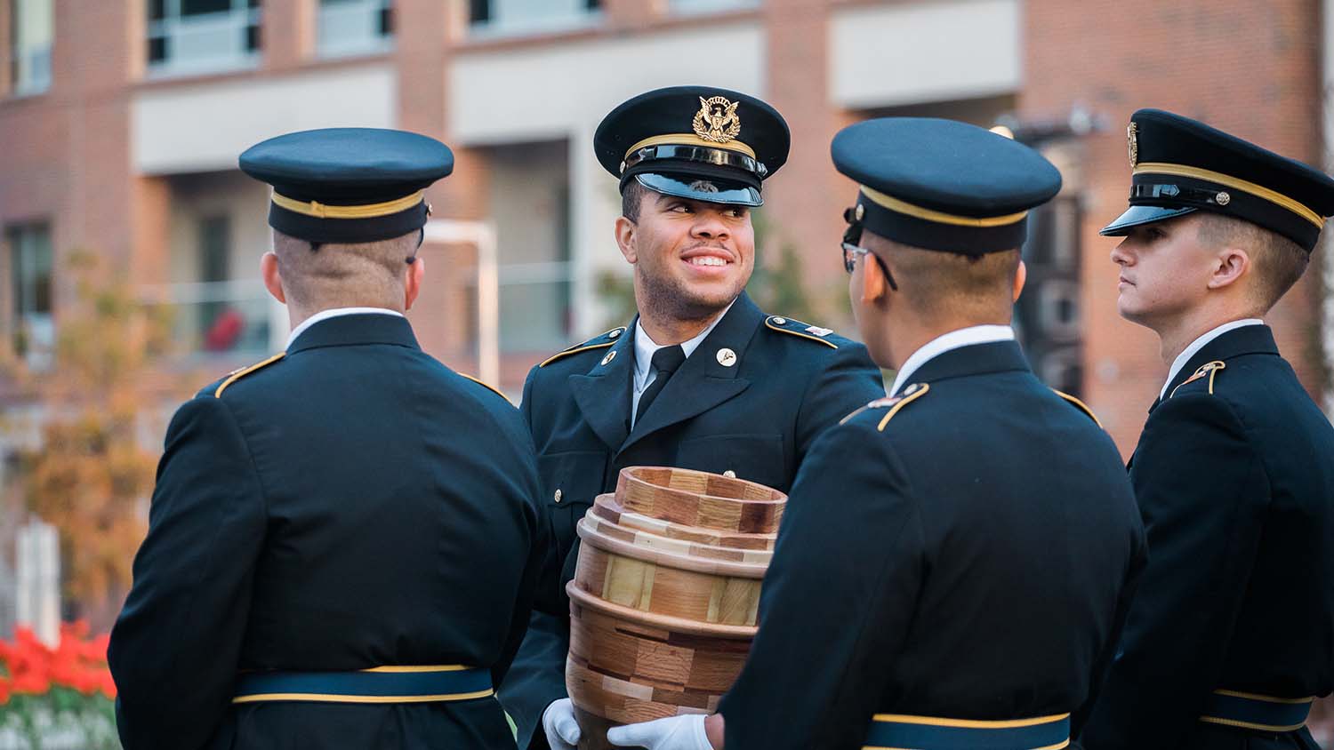 Four ROTC cadets standing together in uniform. 