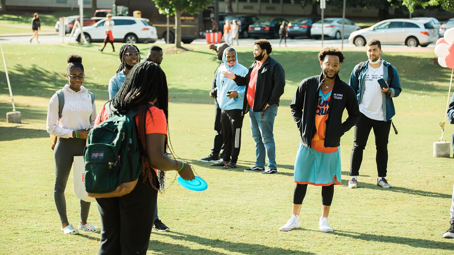 A group of students playing with a frisbee. 