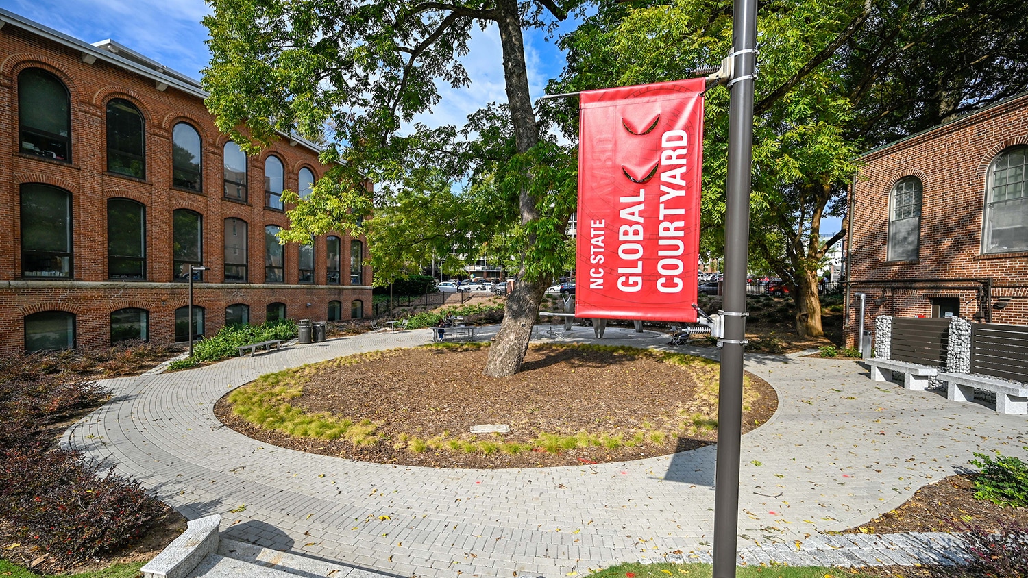 A red banner marks the Global Courtyard on campus.