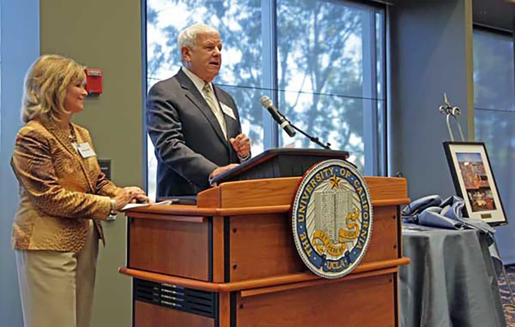 Robin and Albert Carnesale at podium at UCLA.