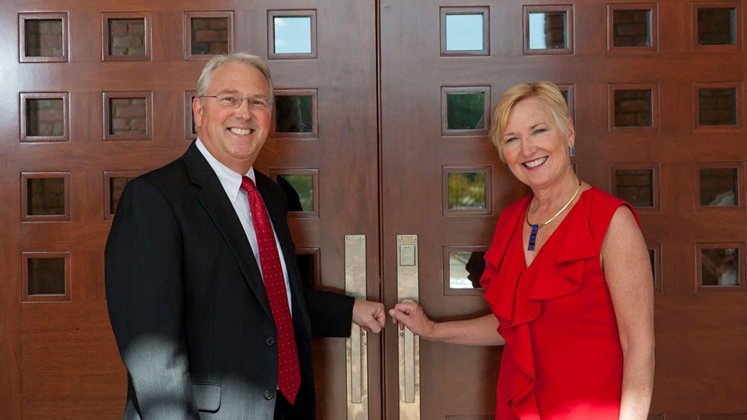 NC State Chancellor Randy Woodson and his wife Susan Woodson at the front doors of their residence, The Point