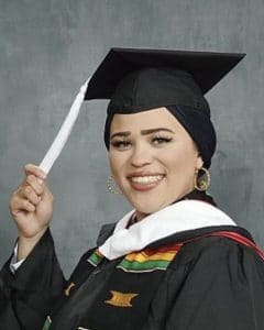 Headshot of Asiya Nasser-Wright wearing a black graduation robe and mortar board. 