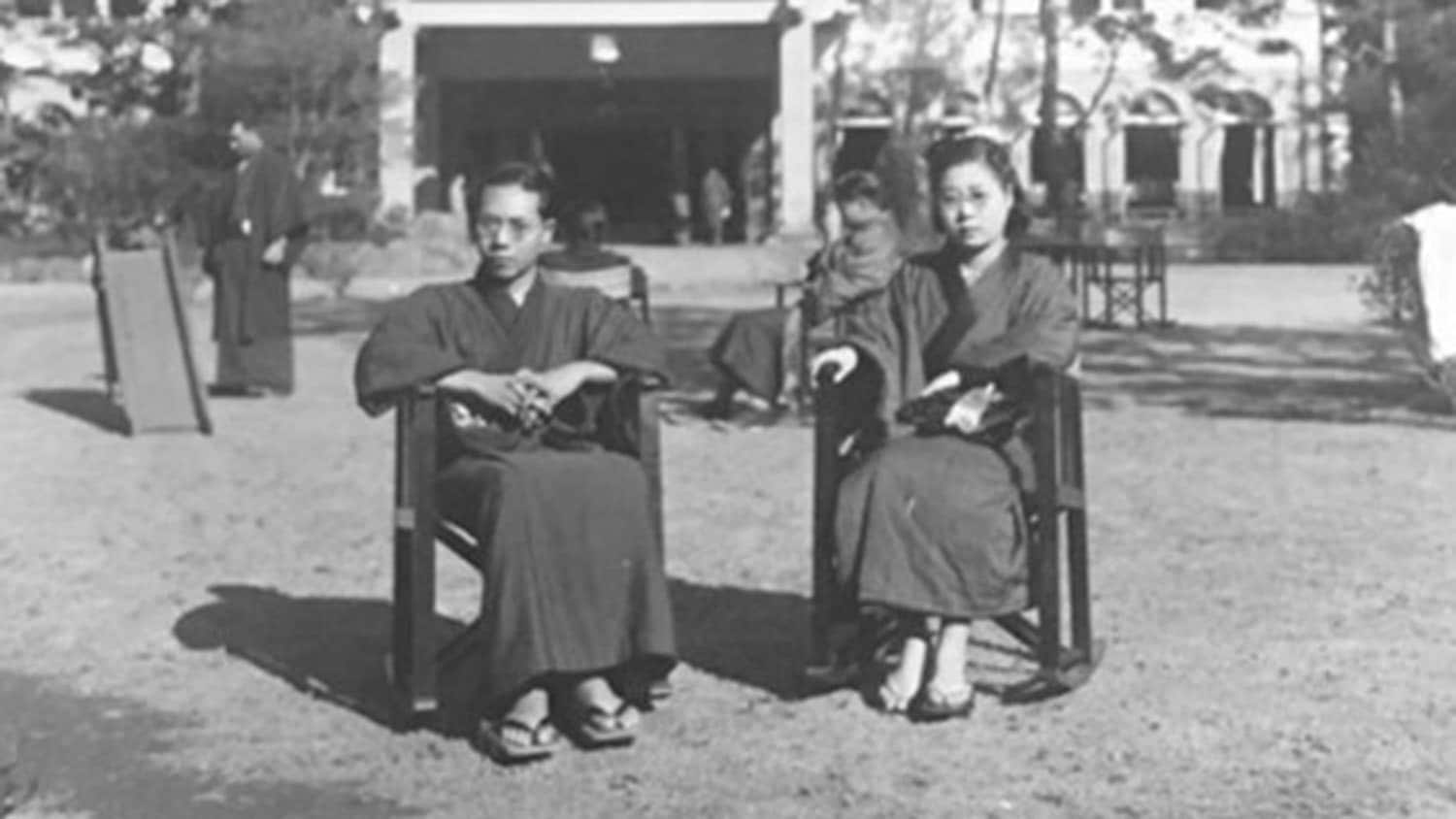 early 20th century photo of a Japanese couple sitting in chairs