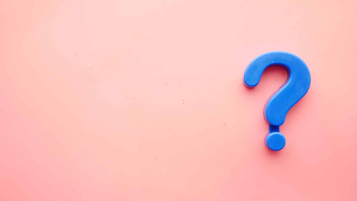 a blue question mark against a pink background