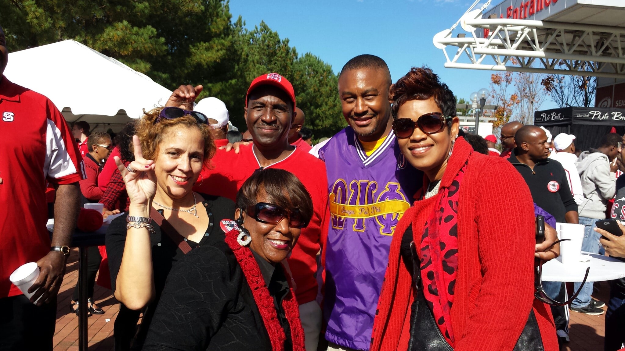 Black Alumni Society members throw up wolf hands during an event.