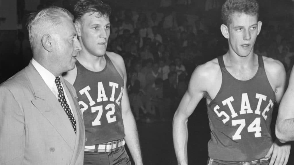 Former NC State men's basketball coach Everett Case talks with his players during the 1954 ACC Tournament. 