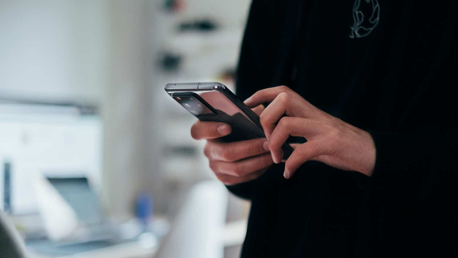 photo shows persons hands holding a smartphone