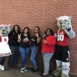 A group of alums pose with the NC State mascots, Mr. and Mrs. Wuf