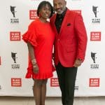 Two alums dressed in red pose at the 2019 BAS Gala