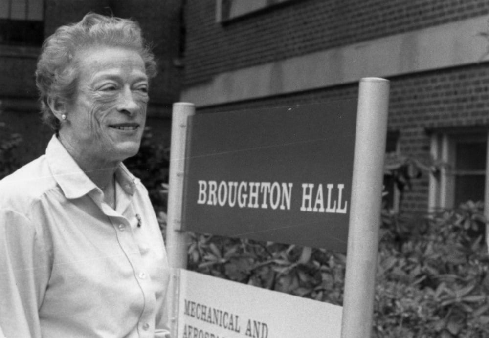 Katharine Stinson standing in front of Broughton Hall.