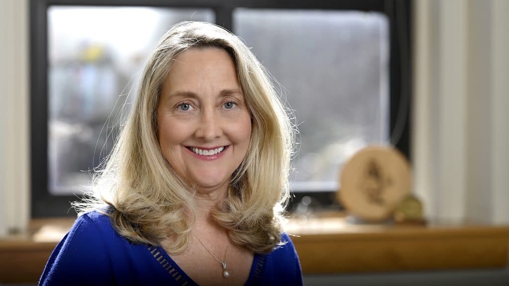 Professor Tracy Appling stands in front of a window in her NC State office.