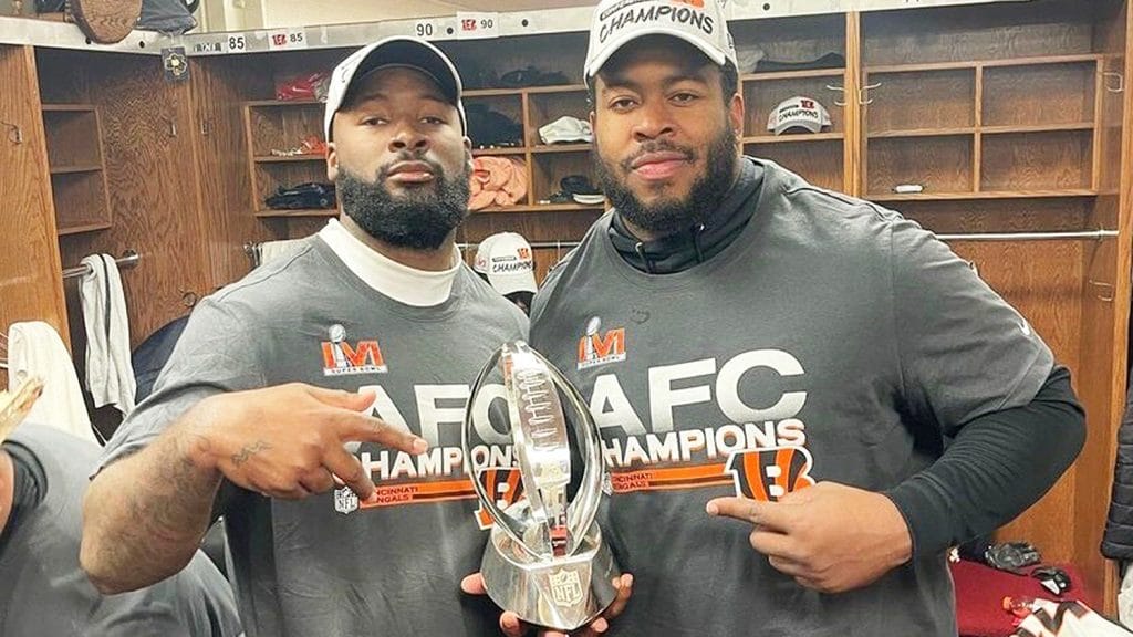 Pratt, left, and Hill celebrate the Bengals' AFC Championship victory in the locker room after the game. 