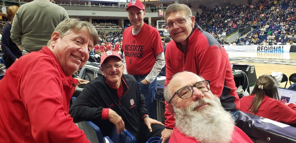 Wes Moore at basketball game surrounded by childhood friends.