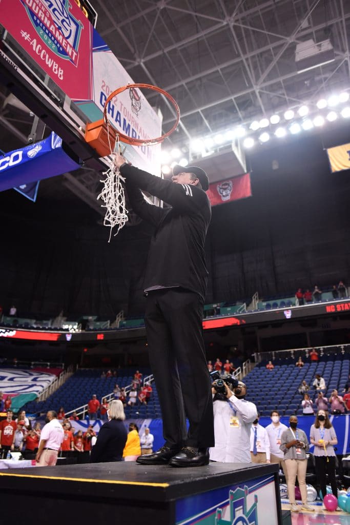 Moore cuts down net after championship game.