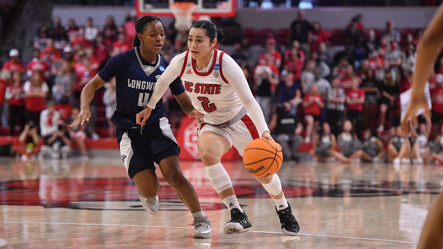 Graduate student Raina Perez drives by a Longwood defender in the first round of the NCAA Championships at Reynolds Coliseum.