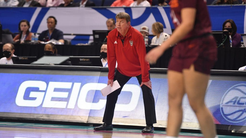 Moore on the sidelines of a basketball game.