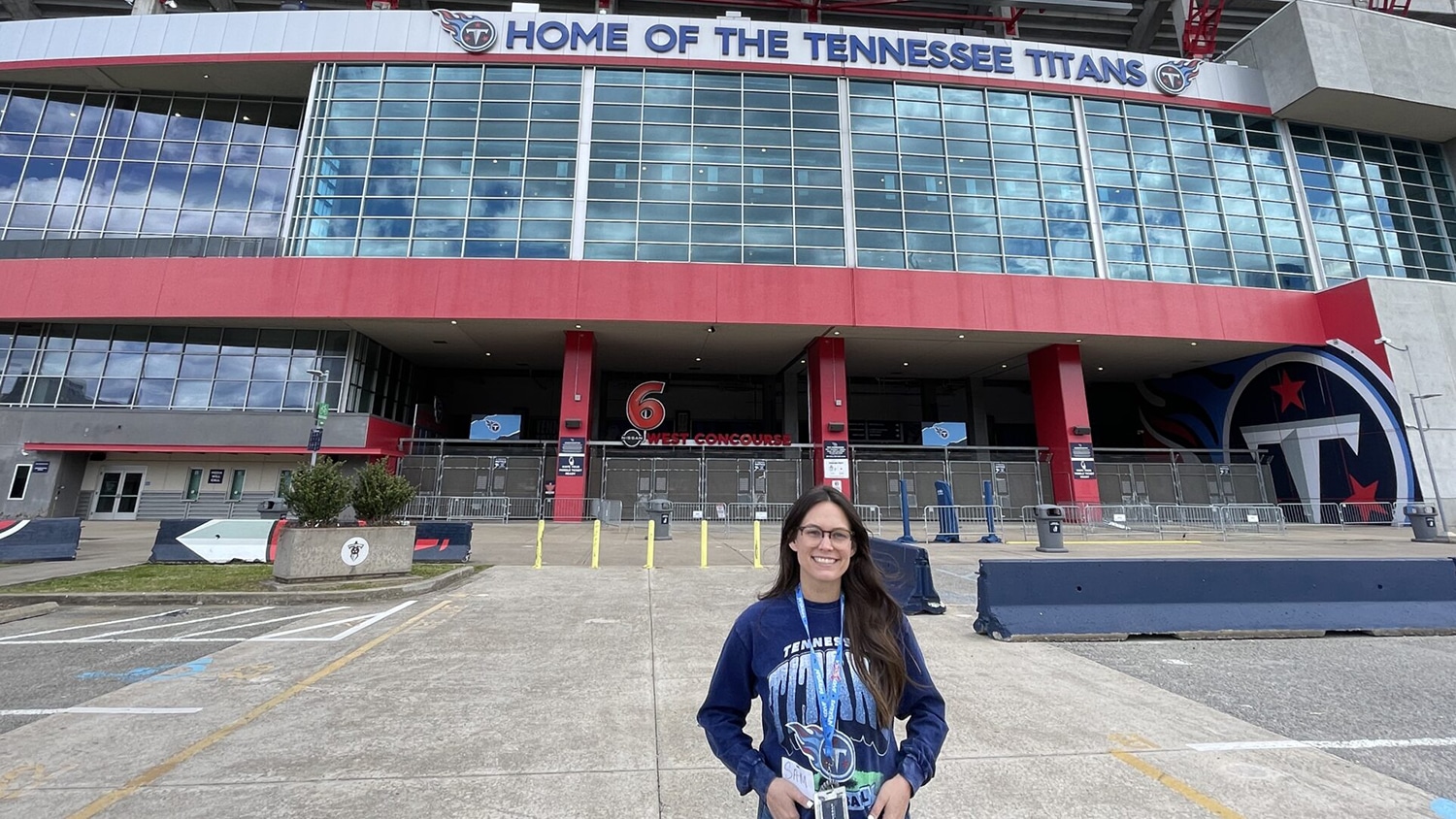woman standing in front of Tennessee Titans football stadium