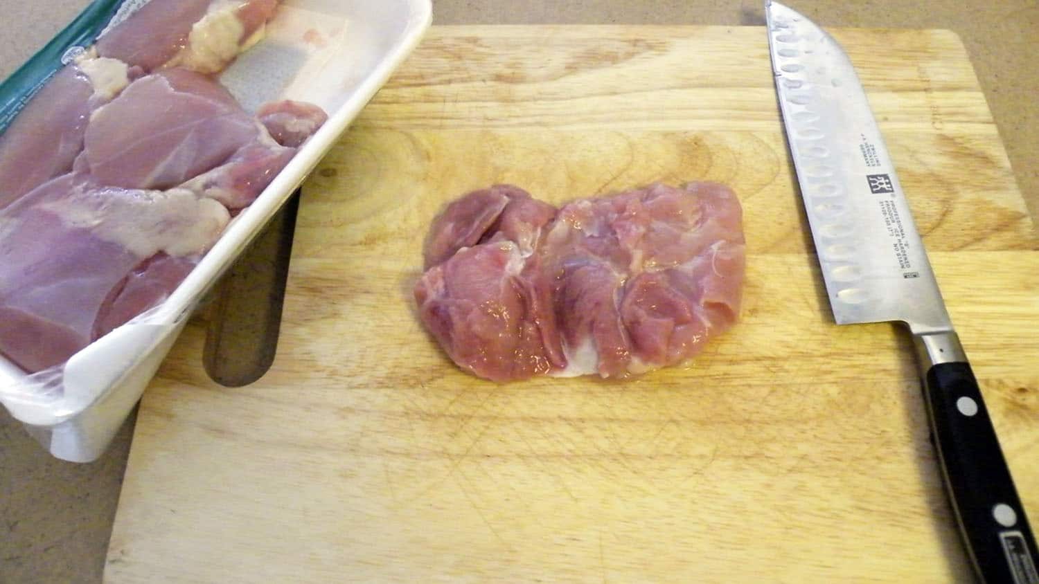 raw chicken thighs on a cutting board
