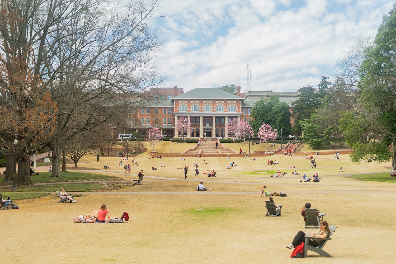Students sit across the Court of North Carolina on a spring day.