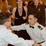 Students in uniform dance together on the dance floor.